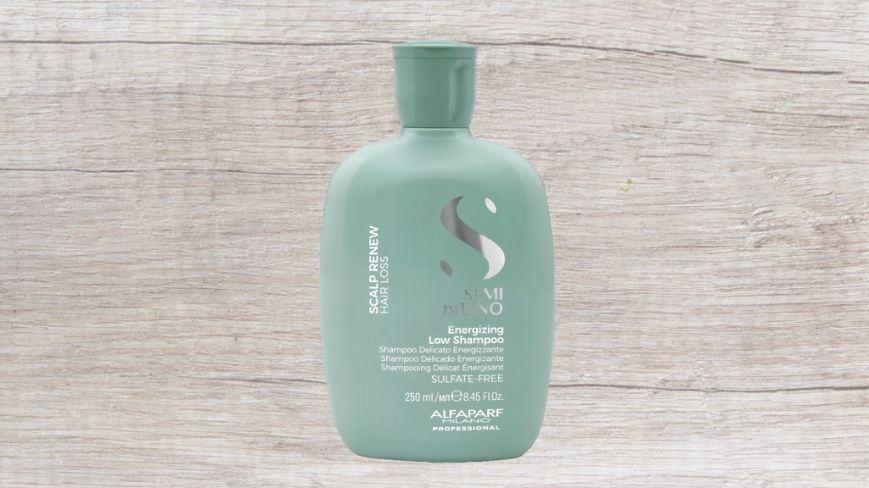 A Bottle of Shampoo is Sitting on a Wooden Table — Superb Hair in Wyong, NSW