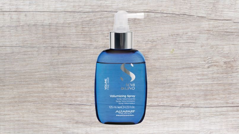 A Blue Bottle of Shampoo is Sitting on a Wooden Table — Superb Hair in Wyong, NSW