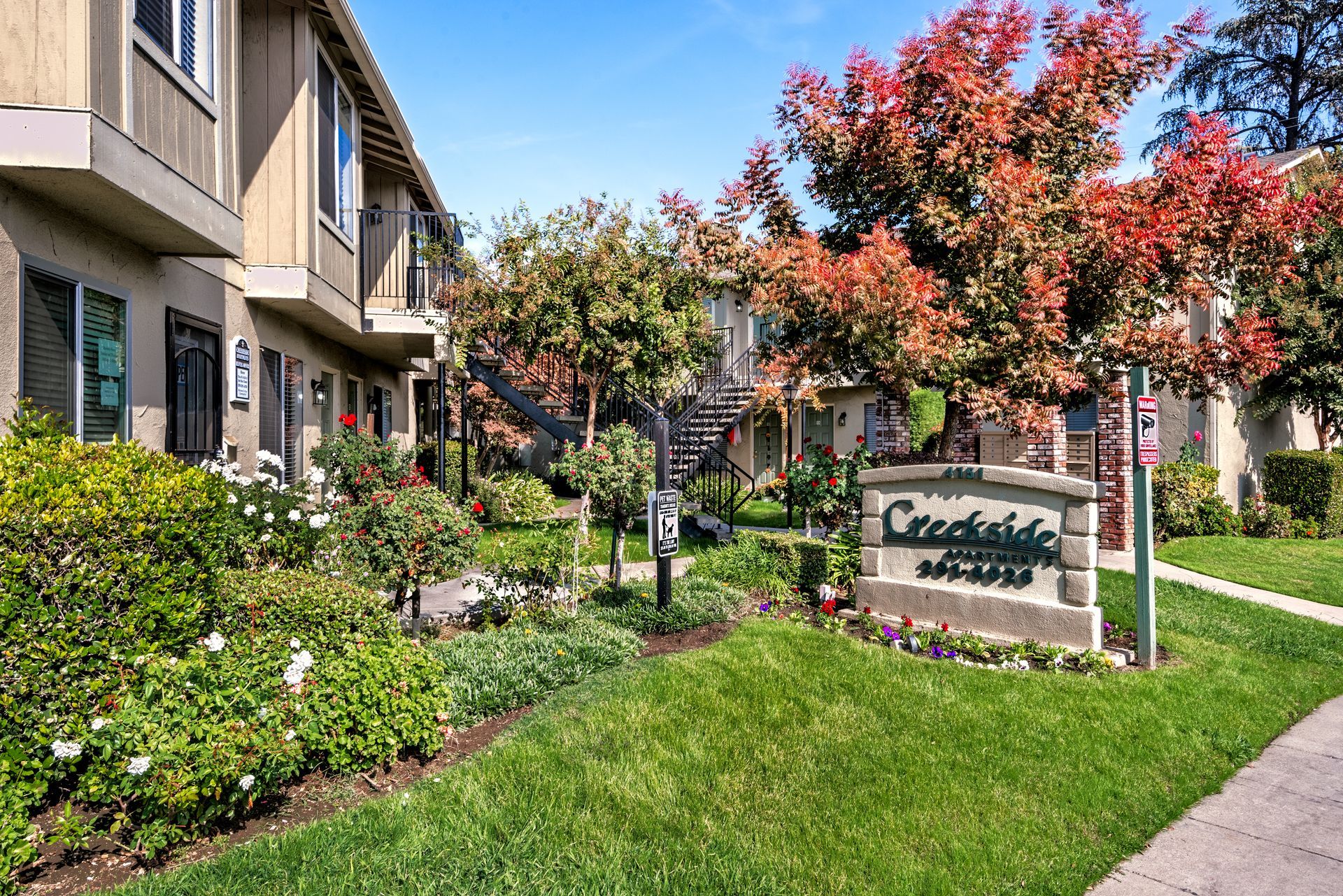 Apartment complex entrance with sign