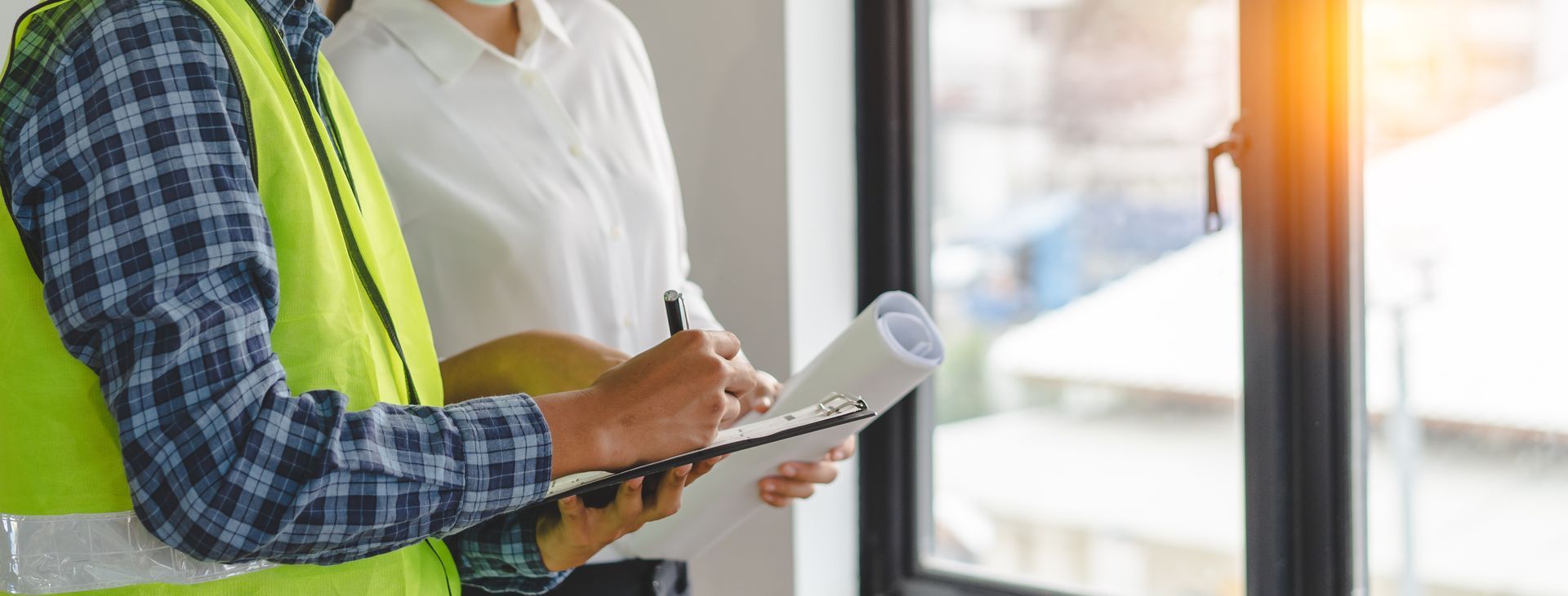 Professional window installers using a checklist to ensure a high-quality window installation.