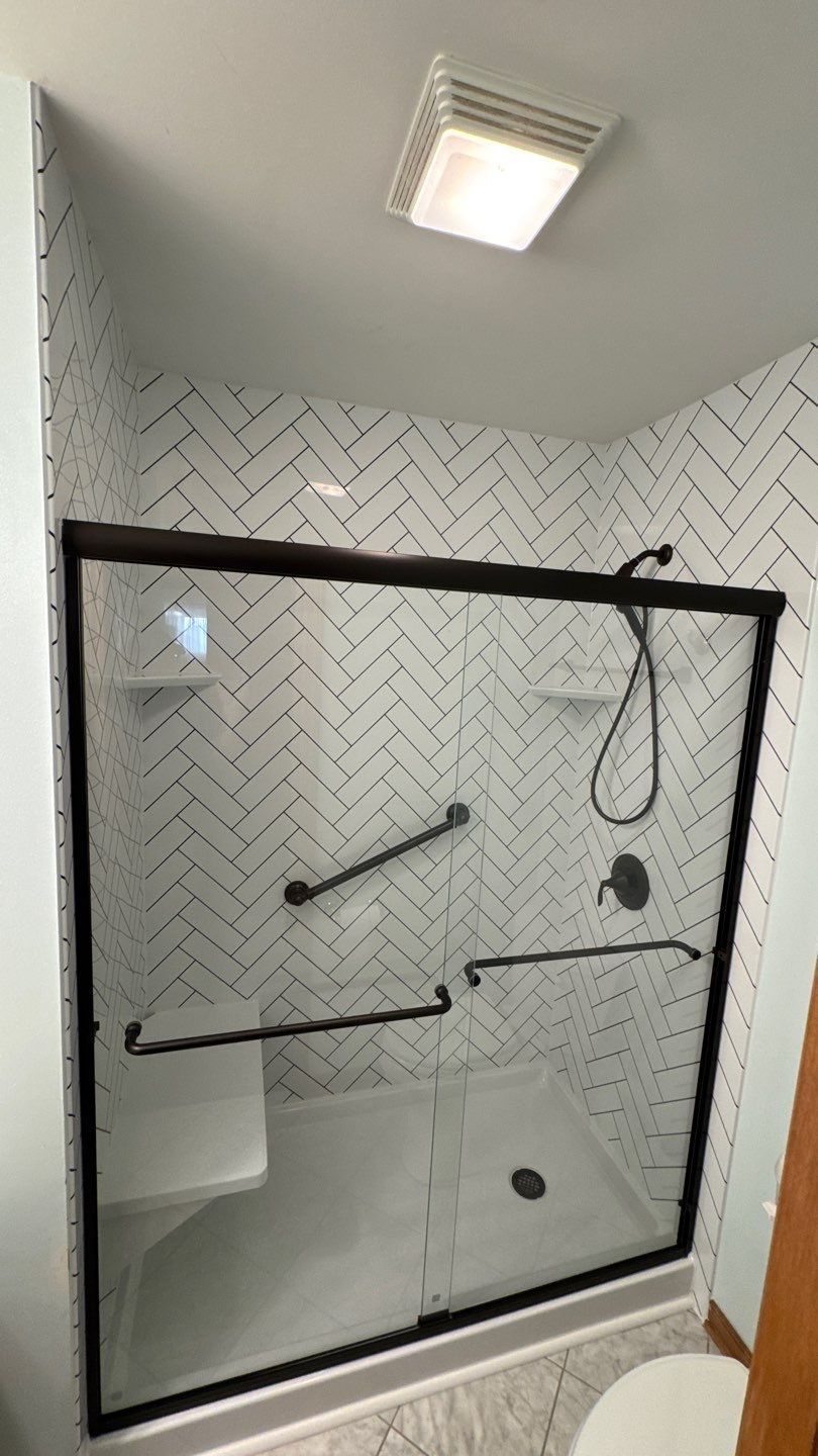 Display stand with a tablet showing a bathroom, in front of a shower display. 