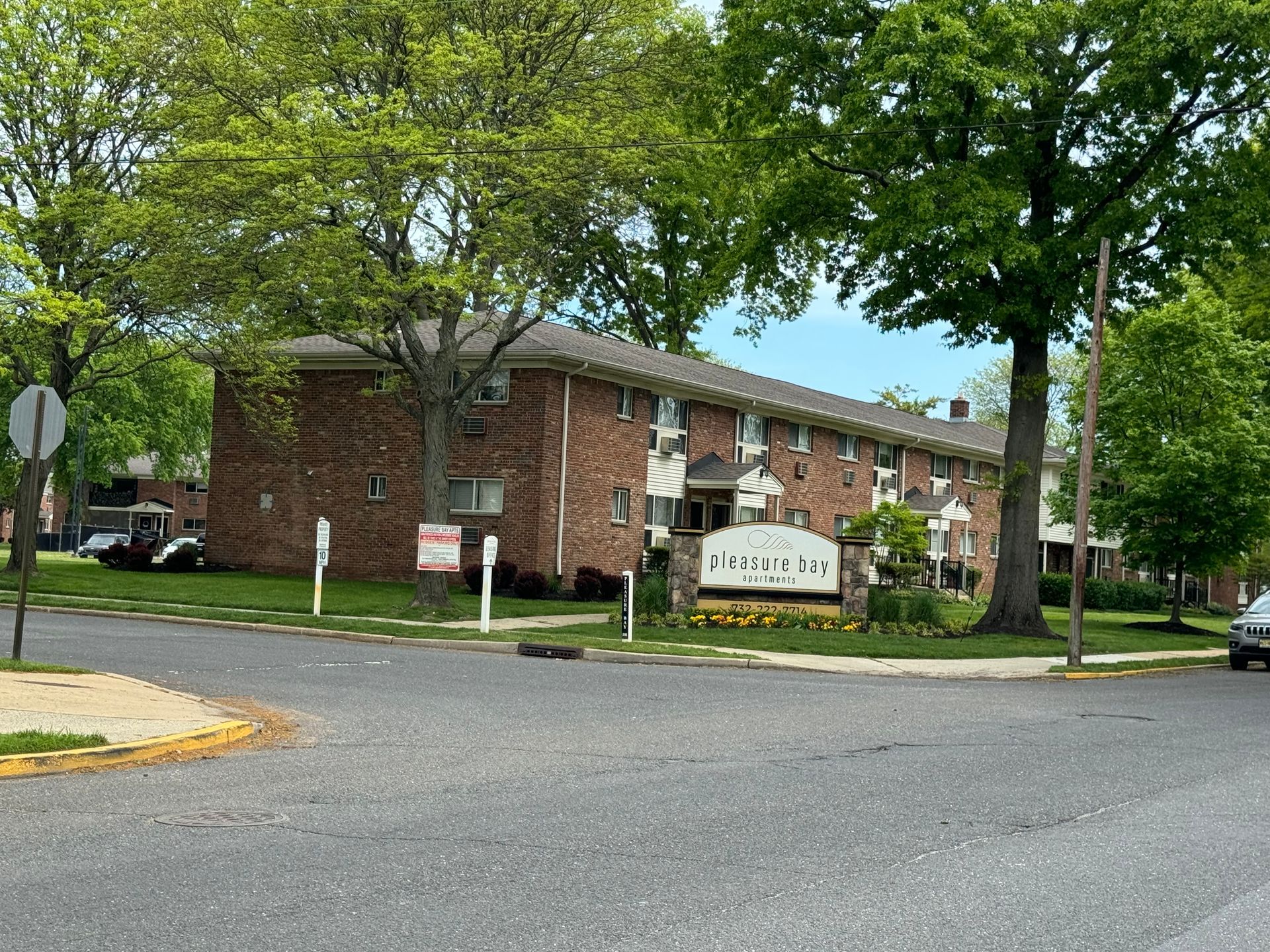 A brick apartment building with a sign that says ' classic ' on it