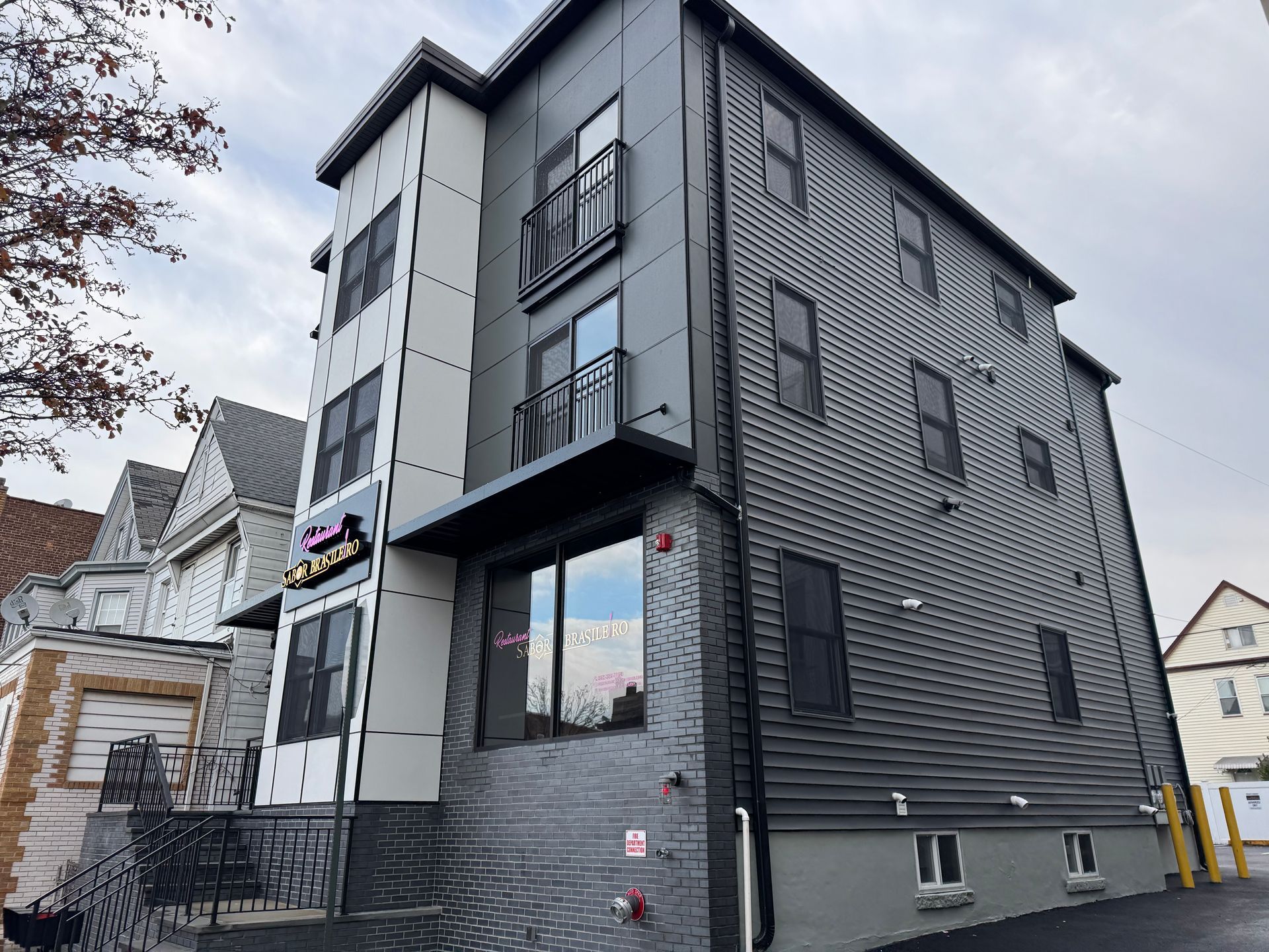 A large building with a lot of windows and a fire hydrant on the side of it.