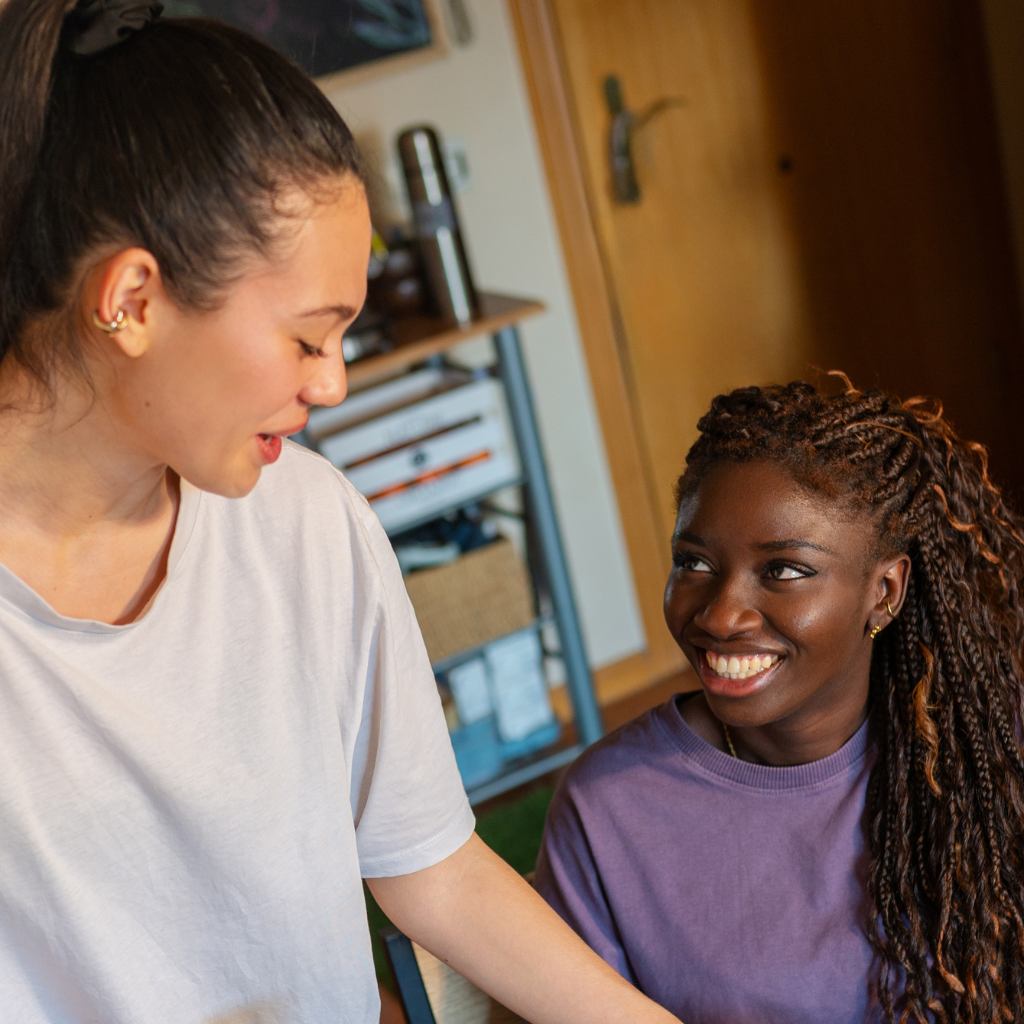 A group of children are practicing karate with a teacher in a gym.