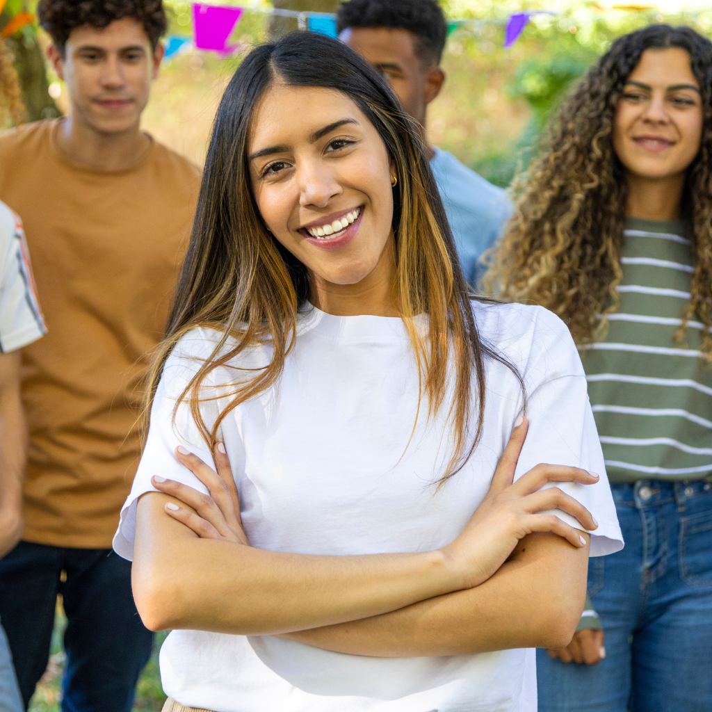 A man is kneeling down next to a young boy in a taekwondo class.