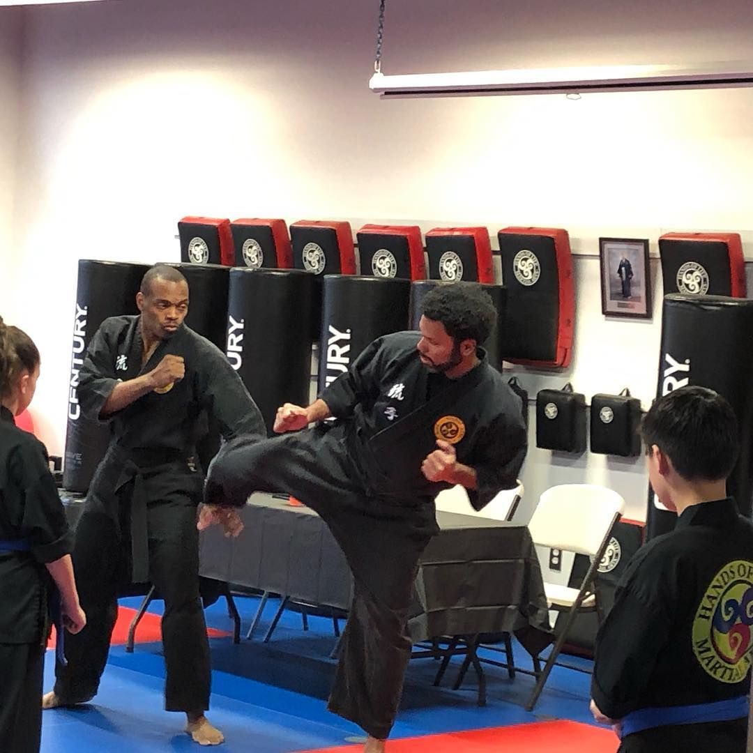 A group of people are practicing martial arts in a gym