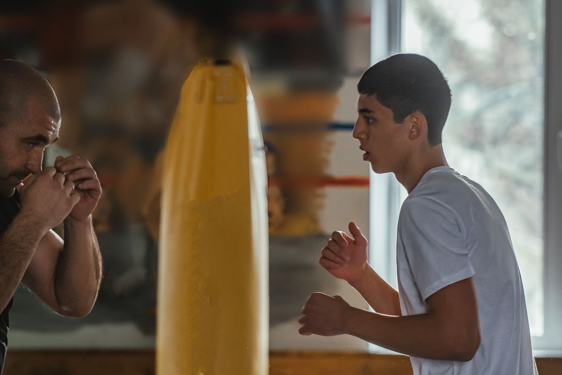 A group of young boys are practicing martial arts in a gym.