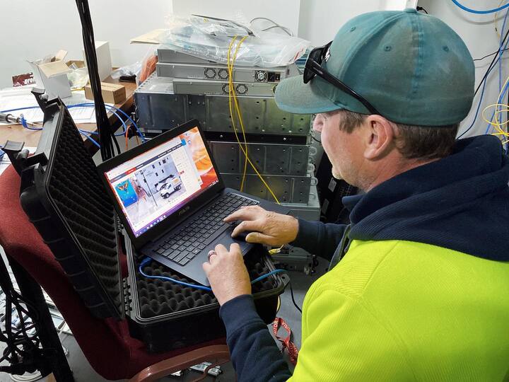 Security worker using laptop — Security Systems in Armidale, NSW
