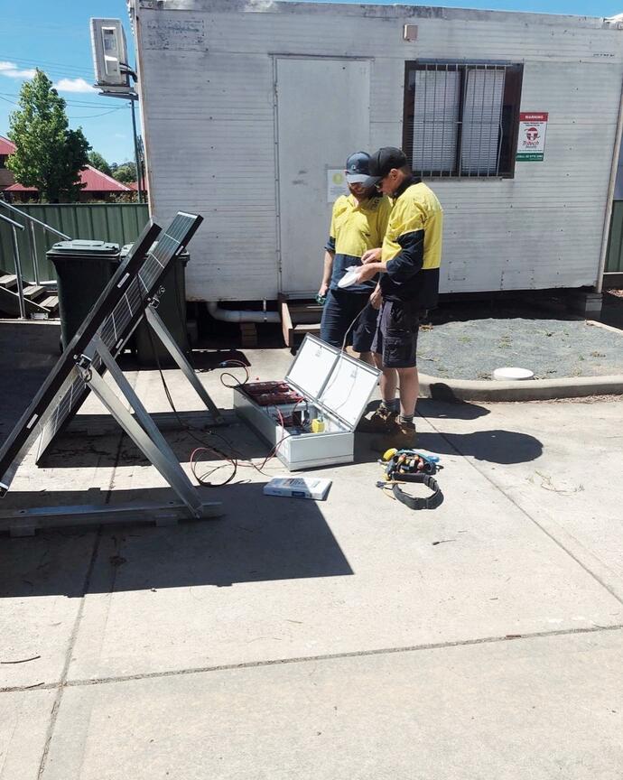 Two security workers fixing panels — Security Systems in Armidale, NSW