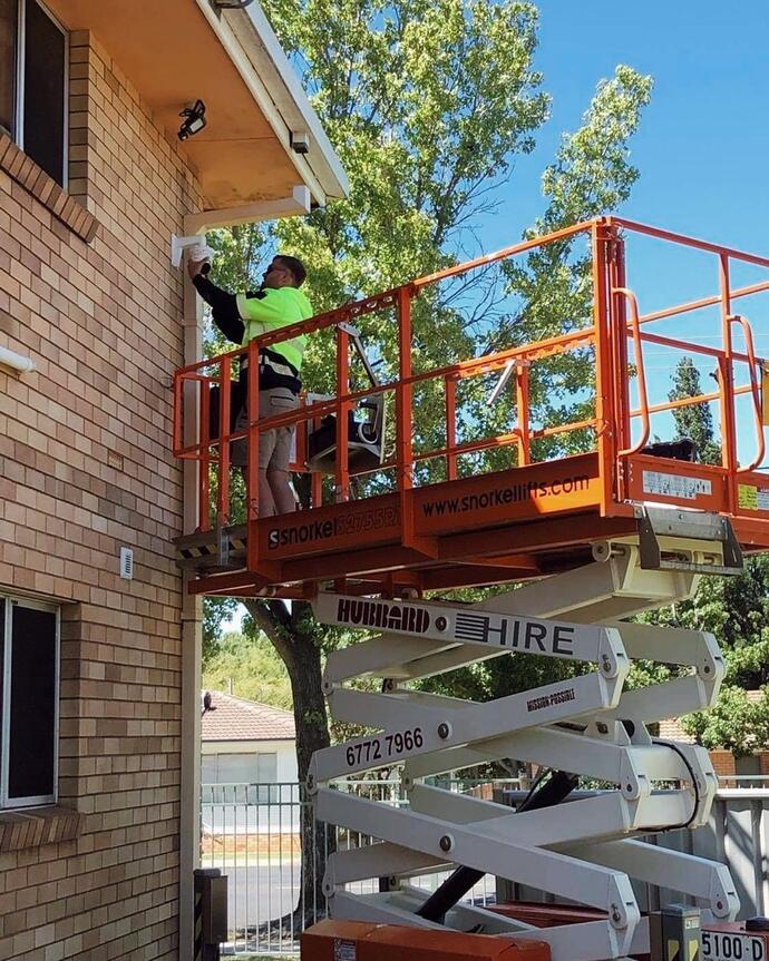Security worker installing CCTV— Security Systems in Armidale, NSW