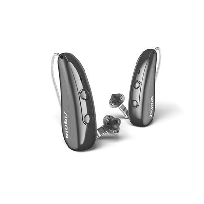 Two dark gray Signia hearing aids with ear tips, angled against a white background.
