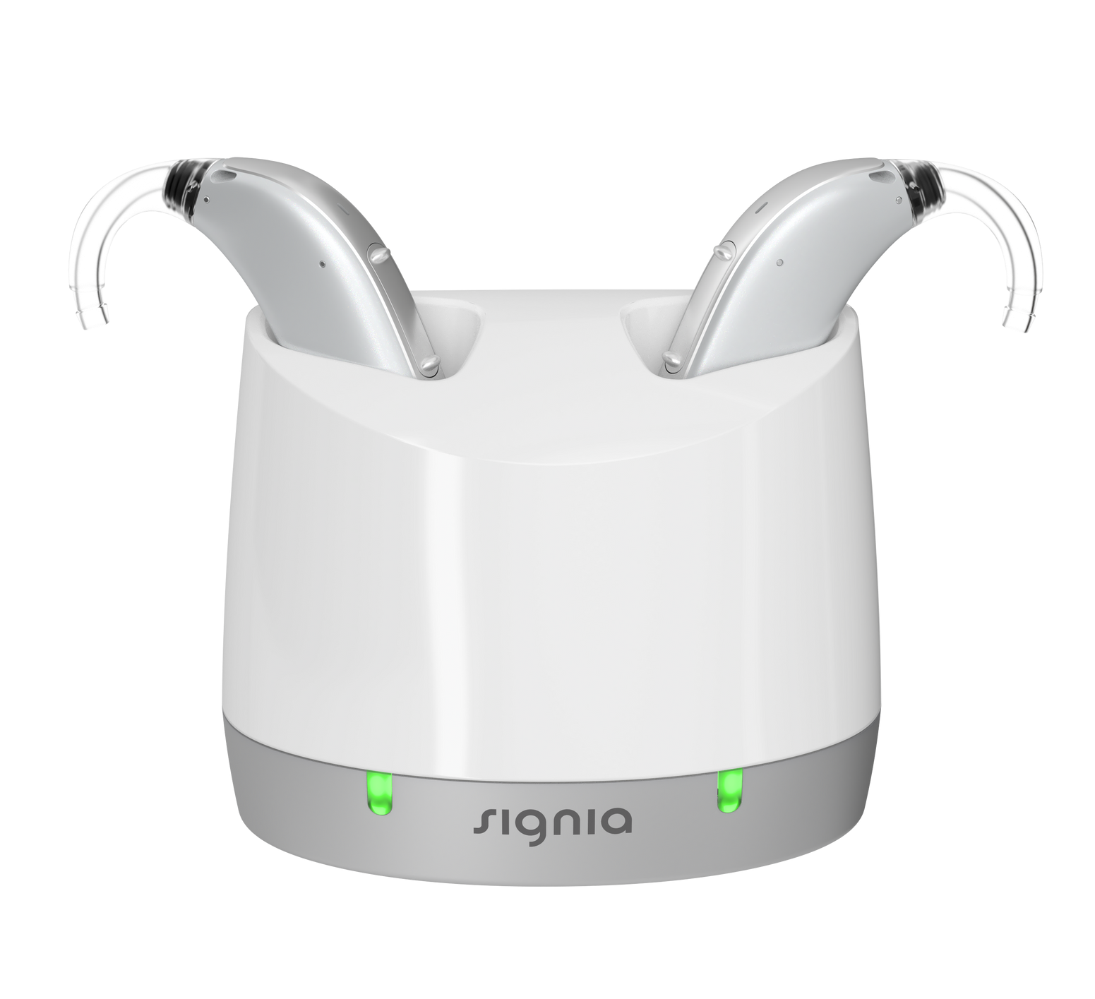 Signia hearing aids charging in a white and gray charging station with green indicator lights.