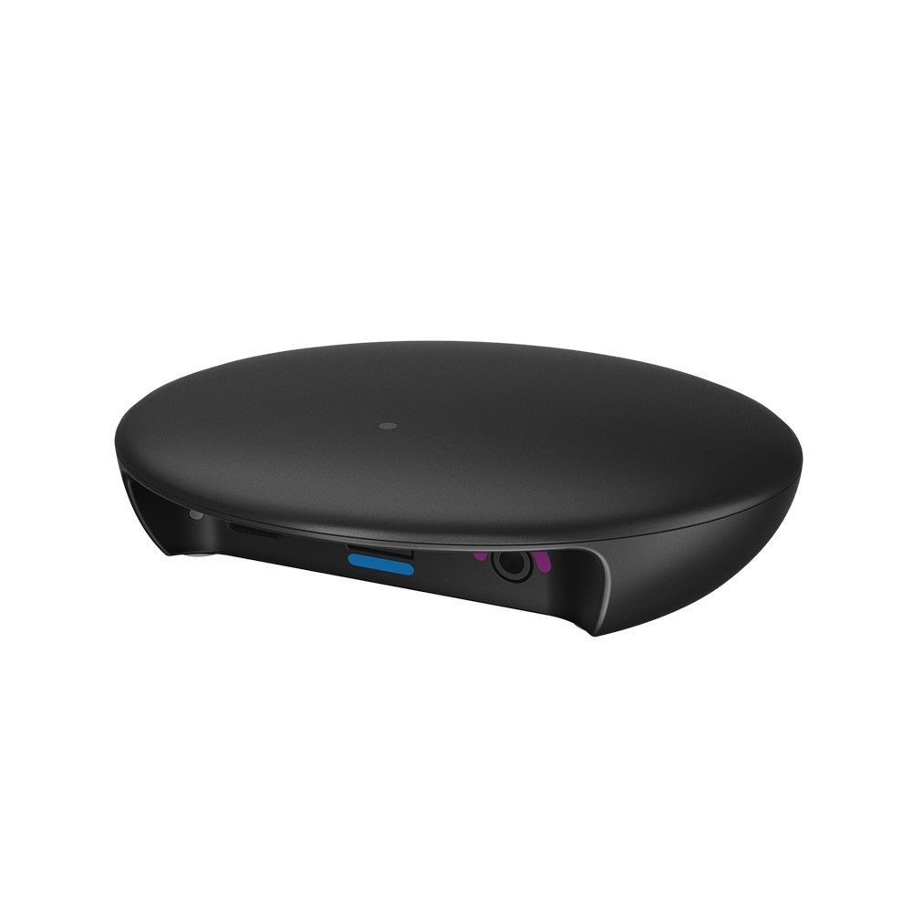 Black, oval-shaped wireless charging pad with a small blue and purple port area on the side.