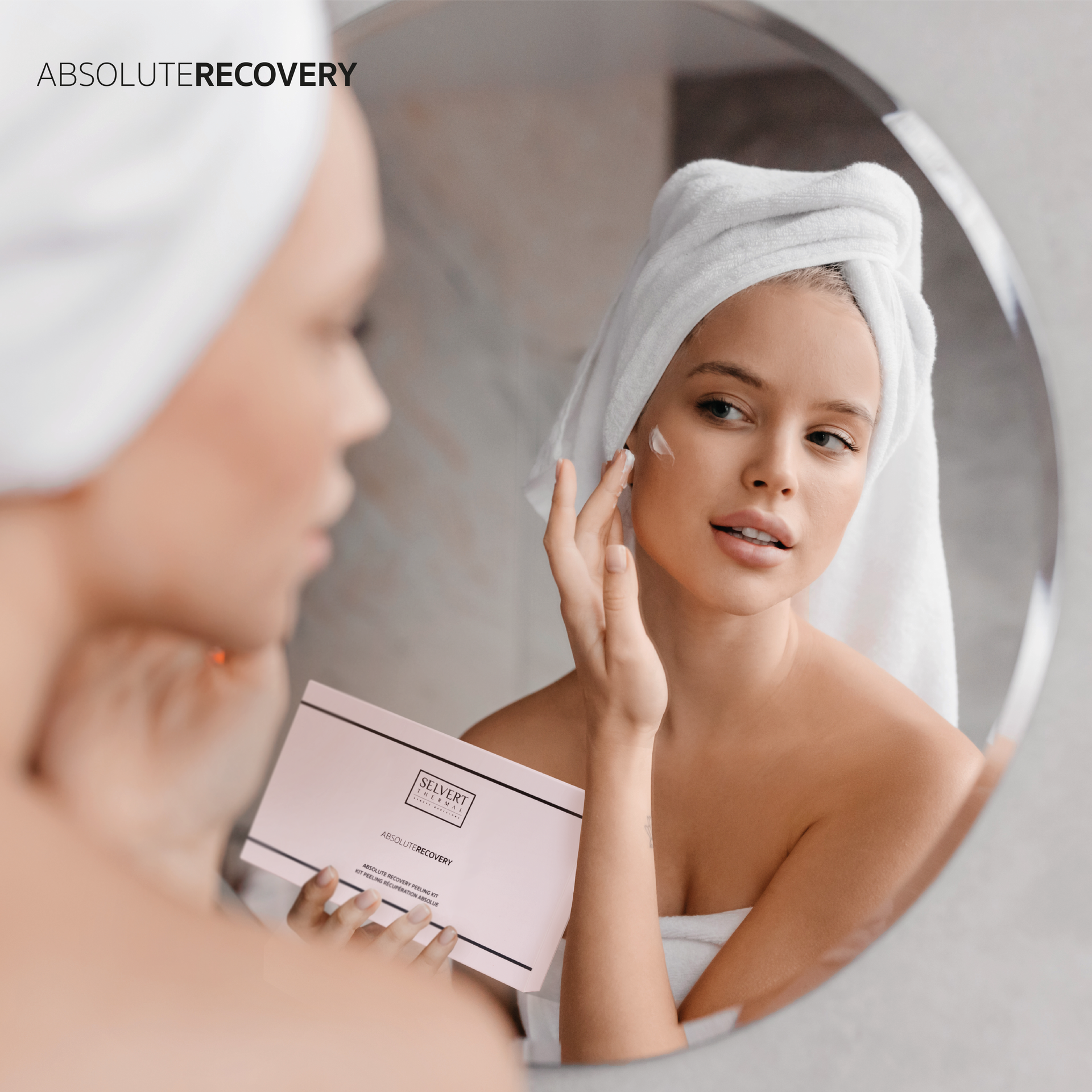 a woman with a towel wrapped around her head is applying cream to her face in front of a mirror .