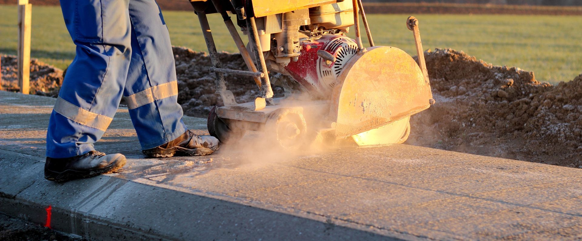 A man is cutting concrete with a circular saw.