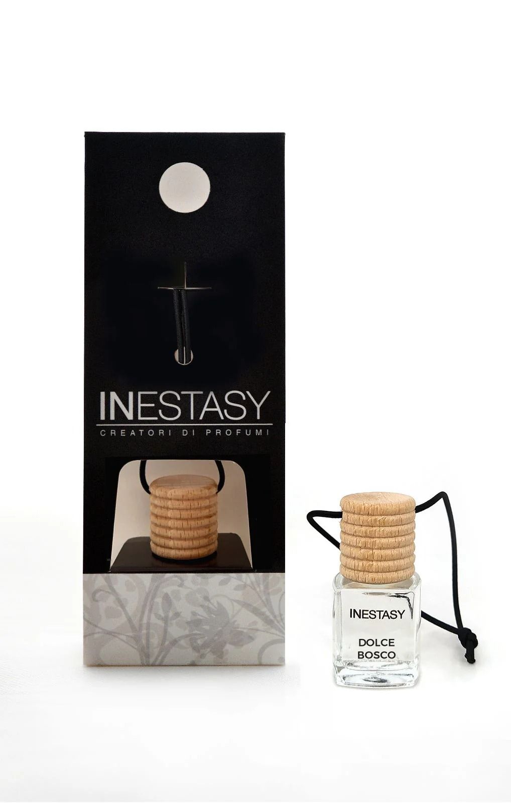 Una piccola bottiglia di profumo inestasy accanto a una scatola.