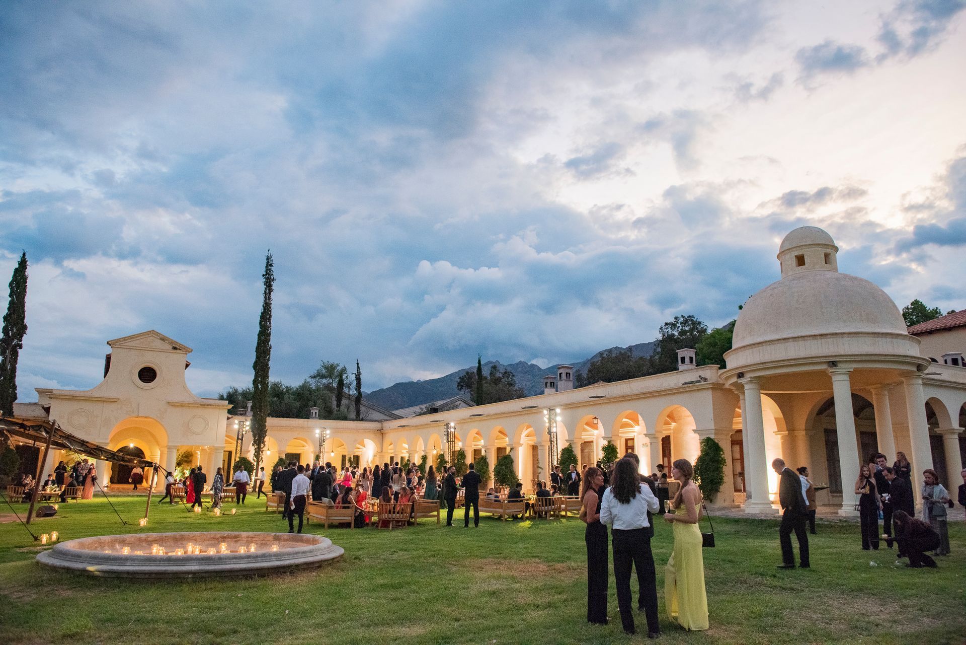 A group of people are standing in front of a large building.