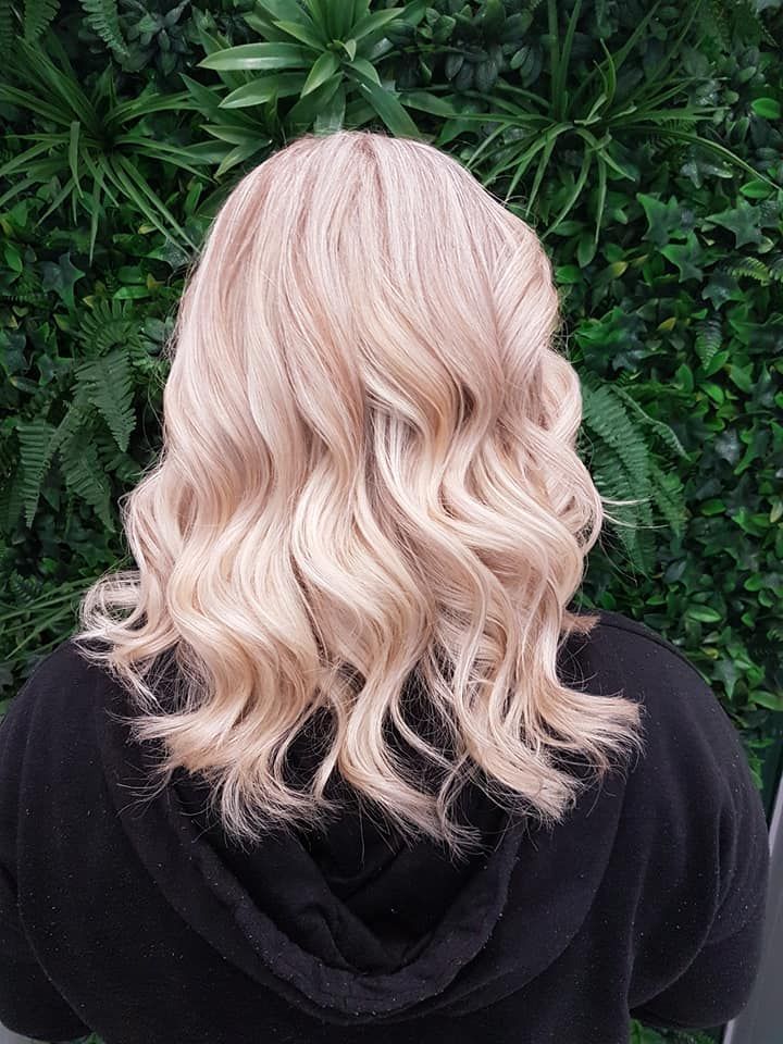 Blonde Wavy Hair Styled, Against a Green Foliage Backdrop — ClaireAbella Hair Studio In Kariong, NSW