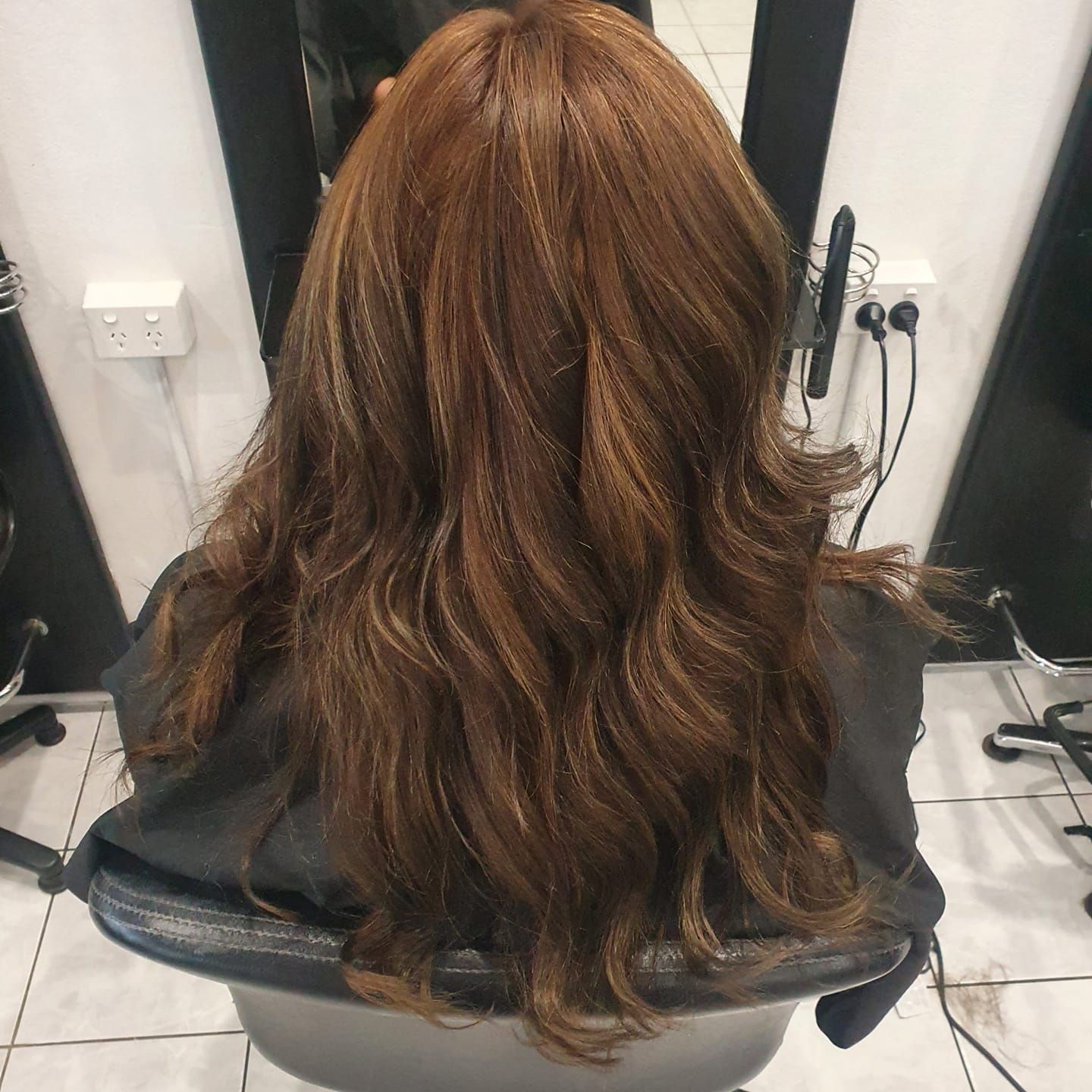 Long Brown Wavy Hair With Blonde Highlights at a Salon, View From the Back — ClaireAbella Hair Studio In Kariong, NSW