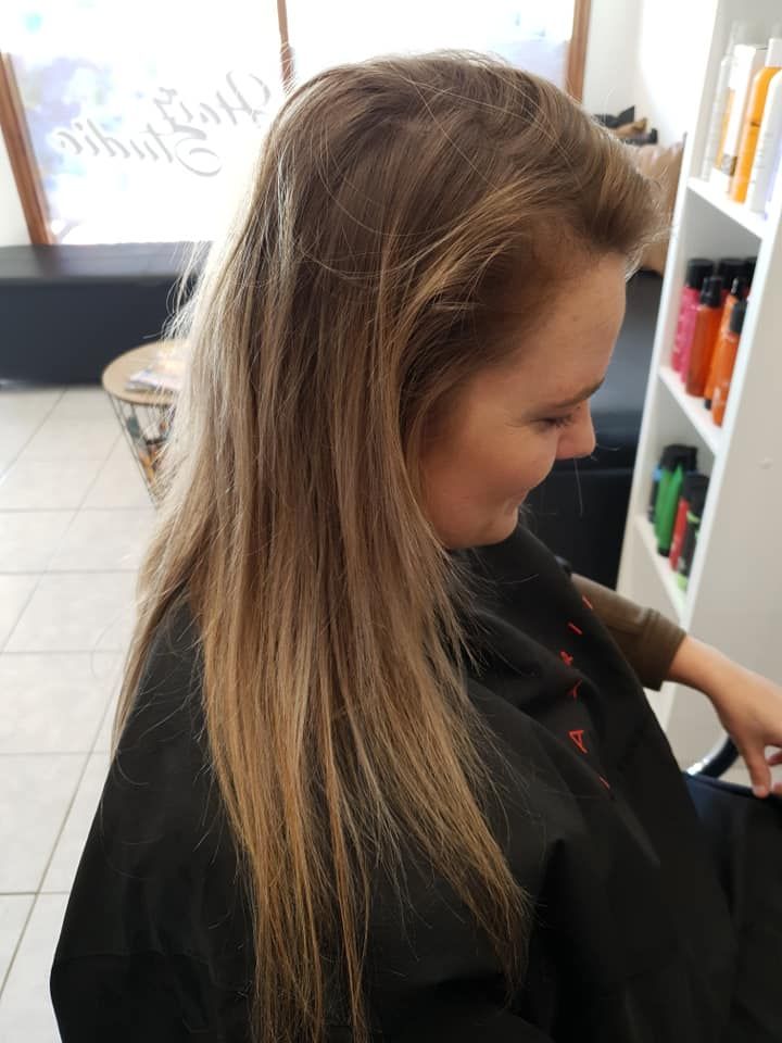 Woman With Long, Light Brown Hair at a Salon, Wearing a Black Cape — ClaireAbella Hair Studio In Kariong, NSW