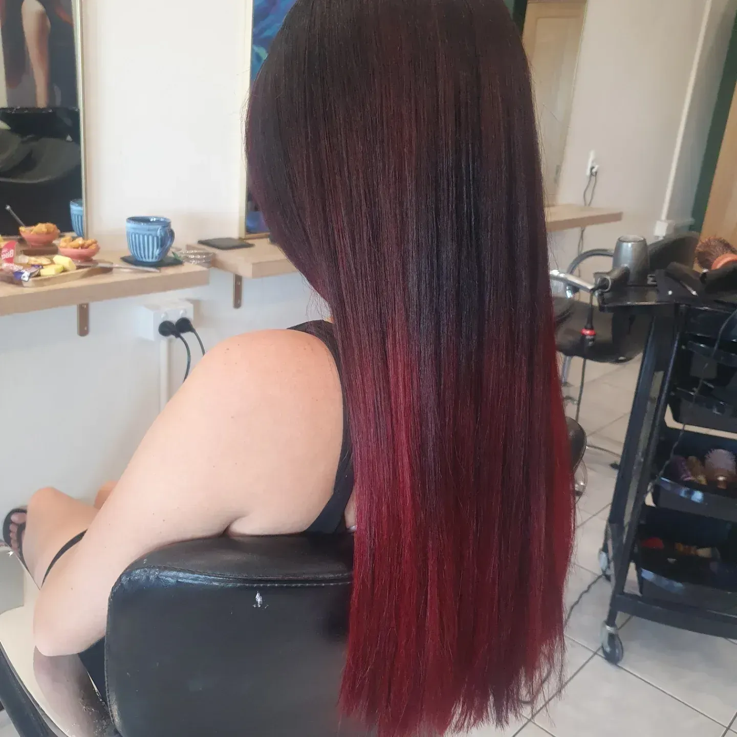Woman With Long Hair Styled in a Gradient, Dark to Red, Seated in a Salon Chair — ClaireAbella Hair Studio In Kariong, NSW