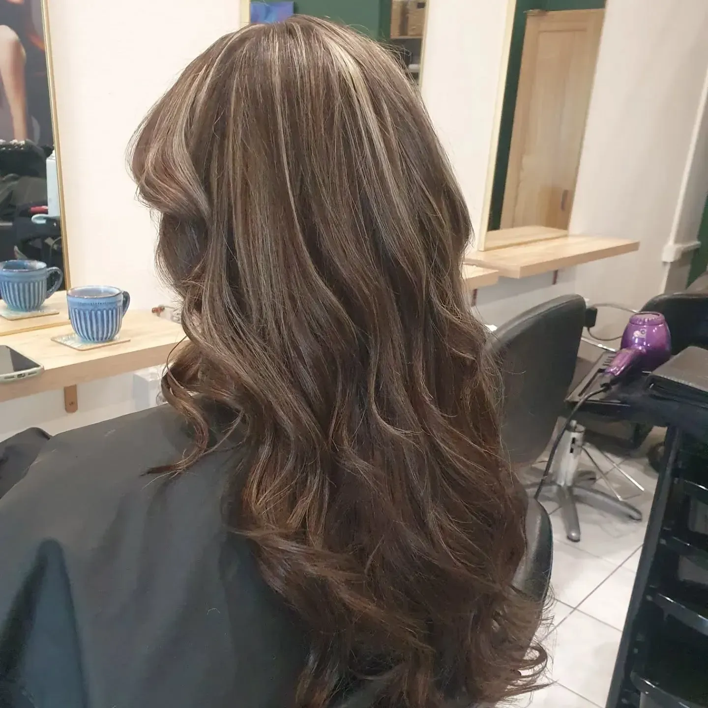 Woman With Long Wavy Brown Hair With Blonde Highlights at a Salon — ClaireAbella Hair Studio In Kariong, NSW