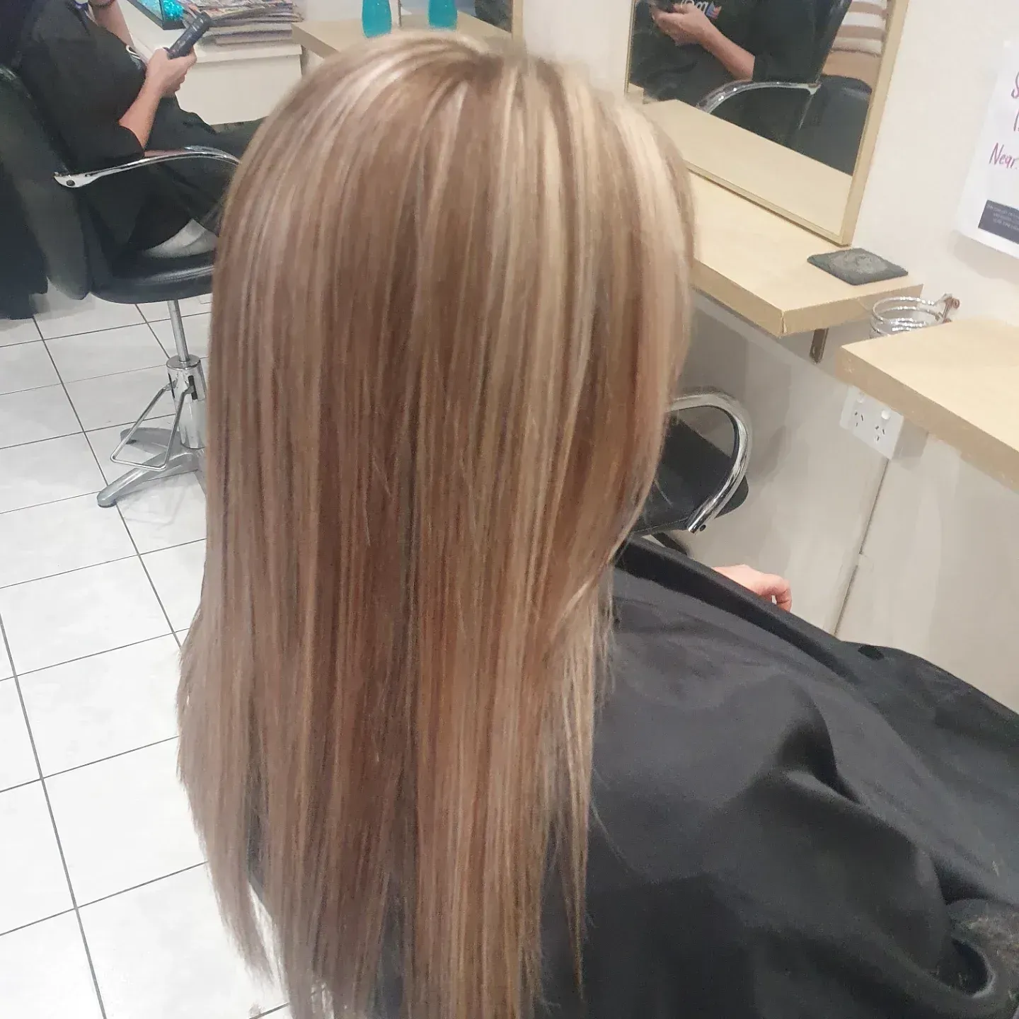 Person With Long, Straight, Highlighted Blonde Hair at a Salon — ClaireAbella Hair Studio In Kariong, NSW