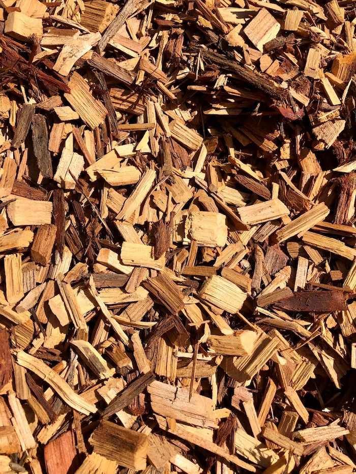 A Pile of Wood Chips is Sitting on the Ground — Highfields Landscape Supplies In Highfields, QLD