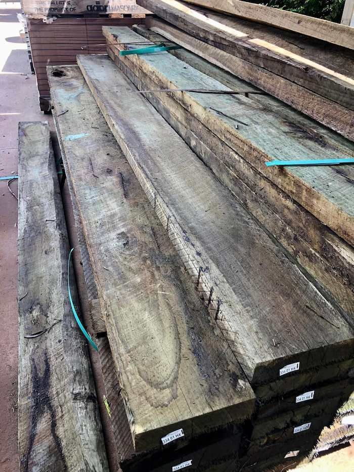 A Stack of Wooden Boards Sitting on Top of Each Other on a Table — Highfields Landscape Supplies In Crows Nest, QLD