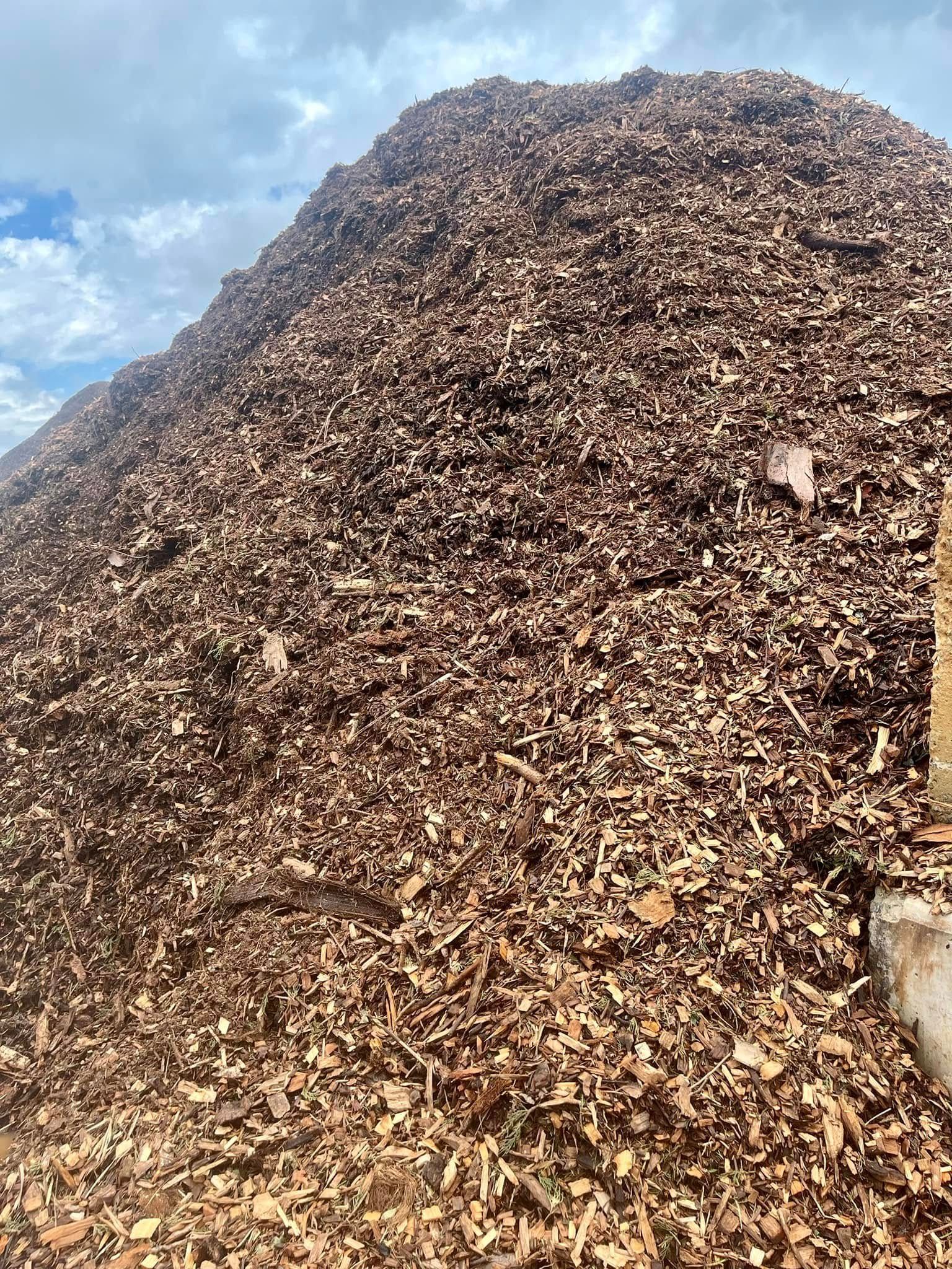 A Pile of Bark With a Sign in the Middle of It — Highfields Landscape Supplies In Meringandan, QLD