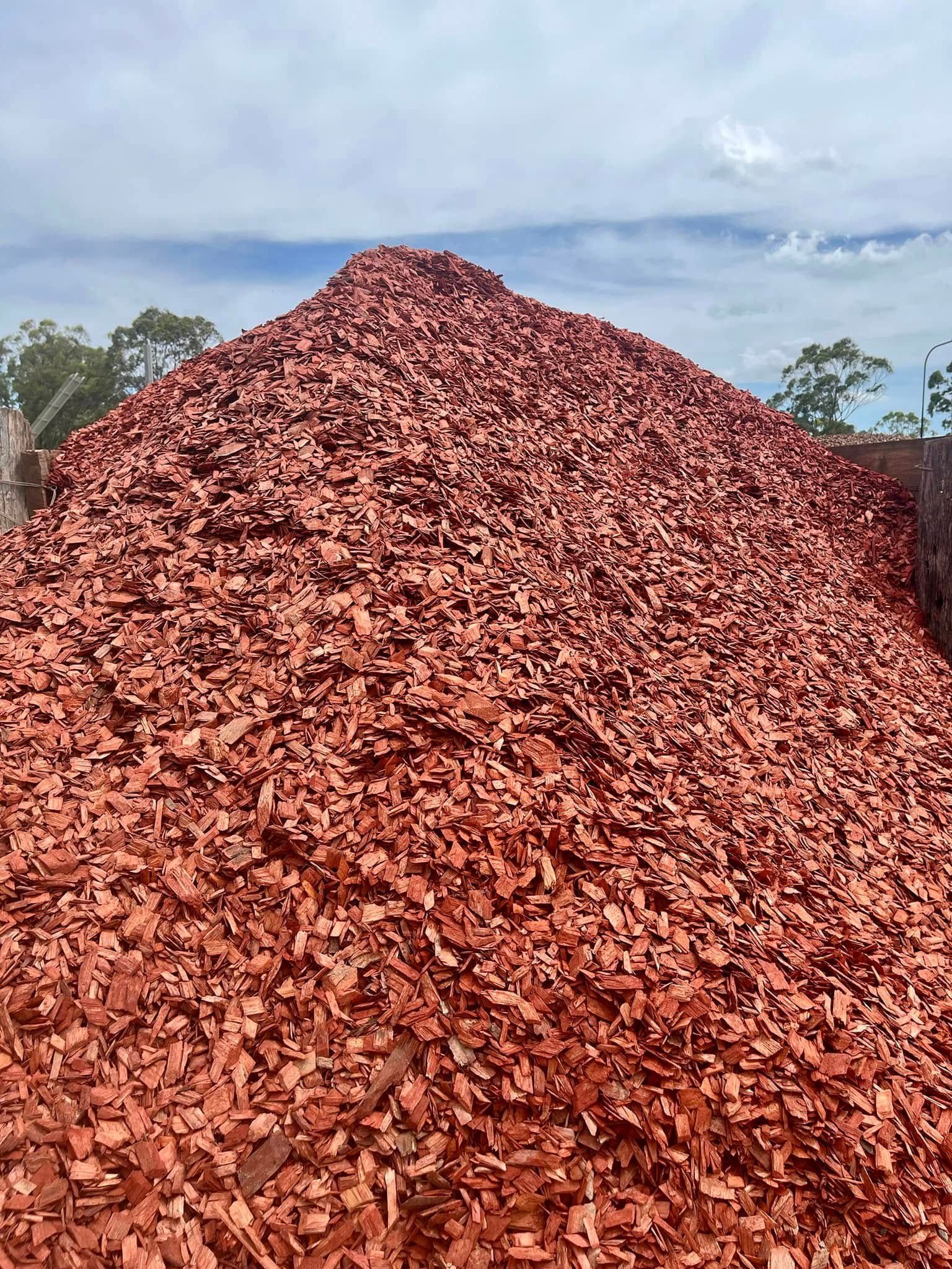 A Pile of Mulch is Sitting in Front of a Building — Highfields Landscape Supplies In Meringandan, QLD