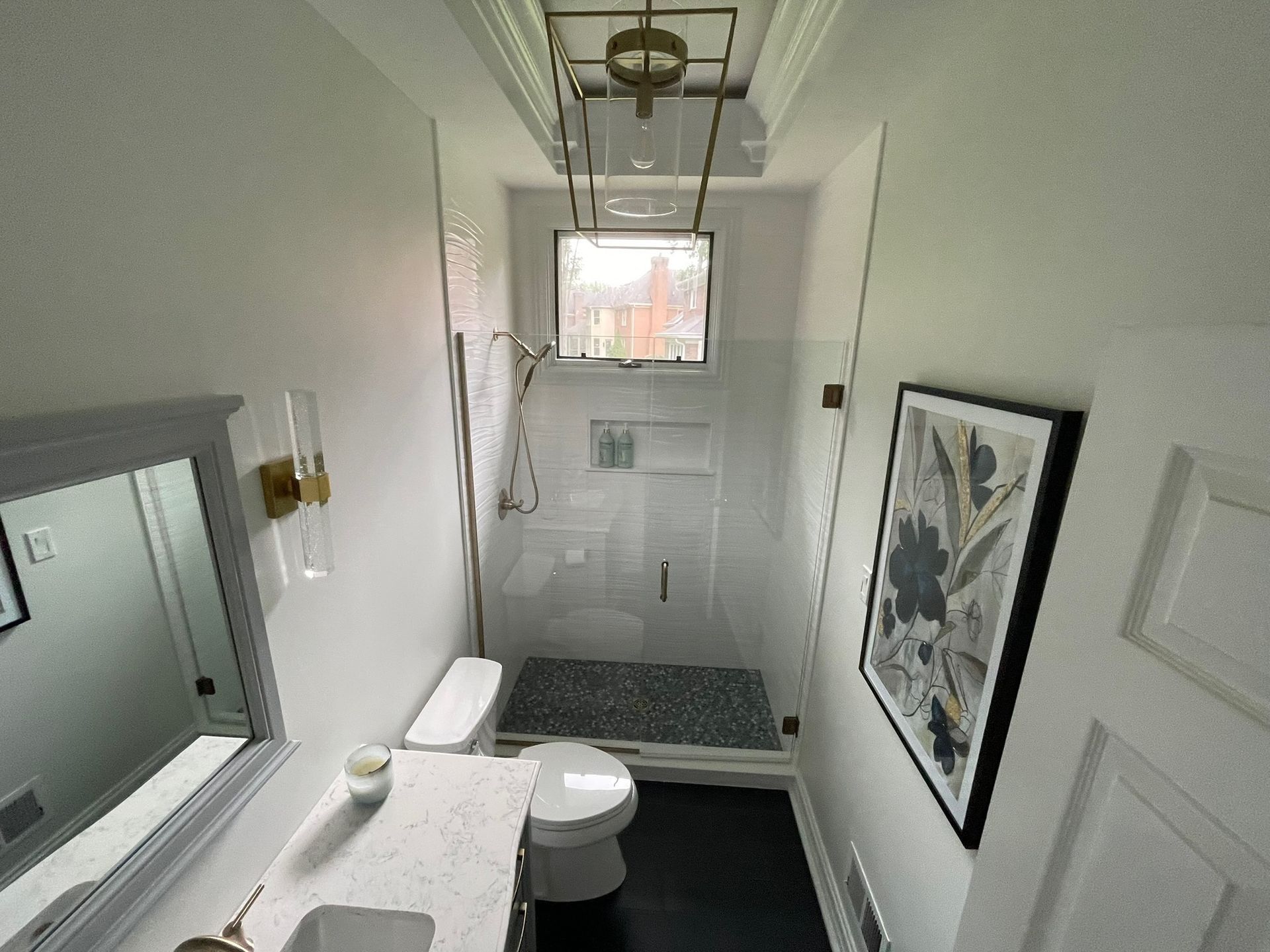 Luxury marble bathroom with freestanding tub and glass shower enclosure.