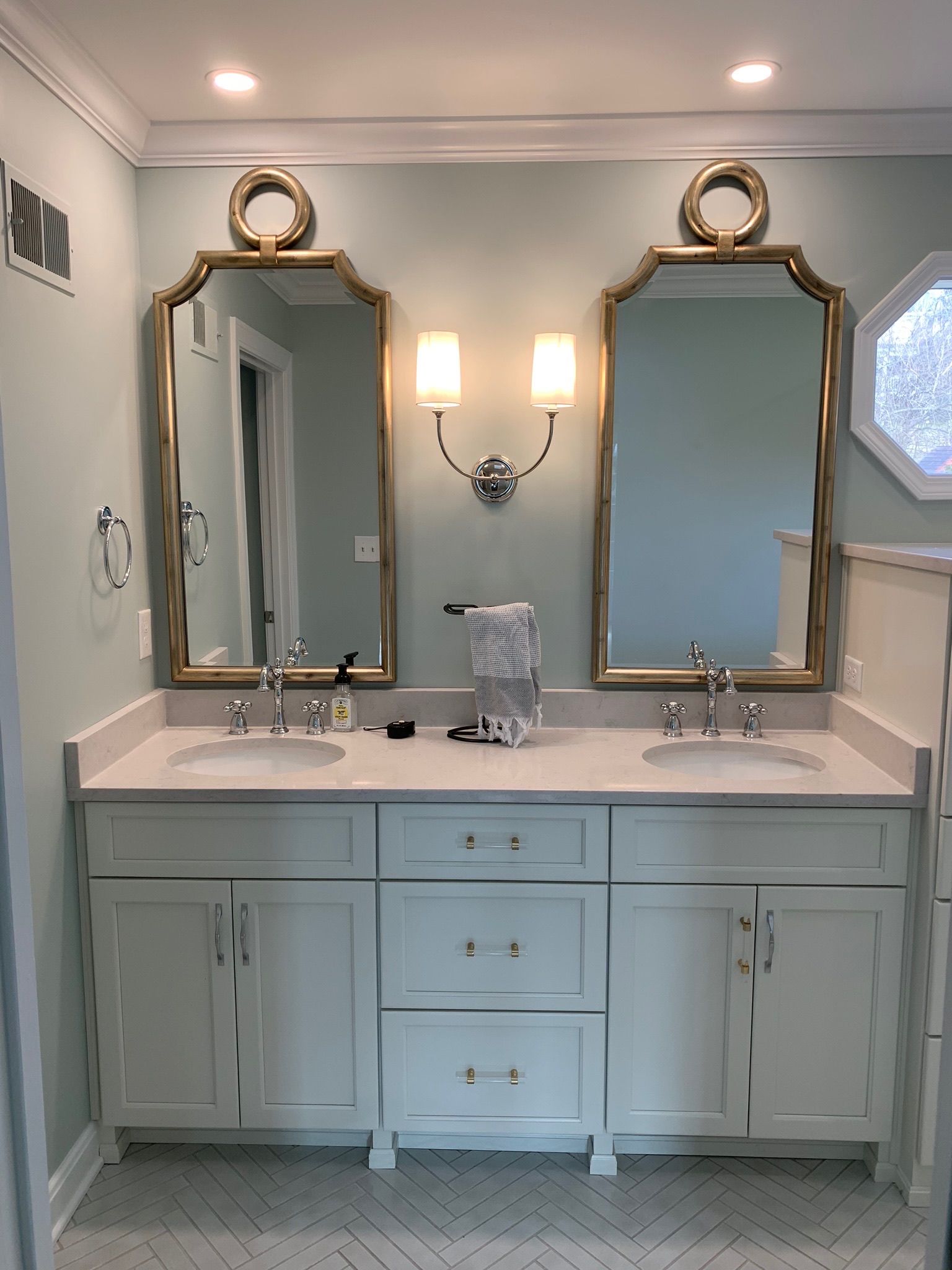 A bathroom with two sinks and two mirrors.