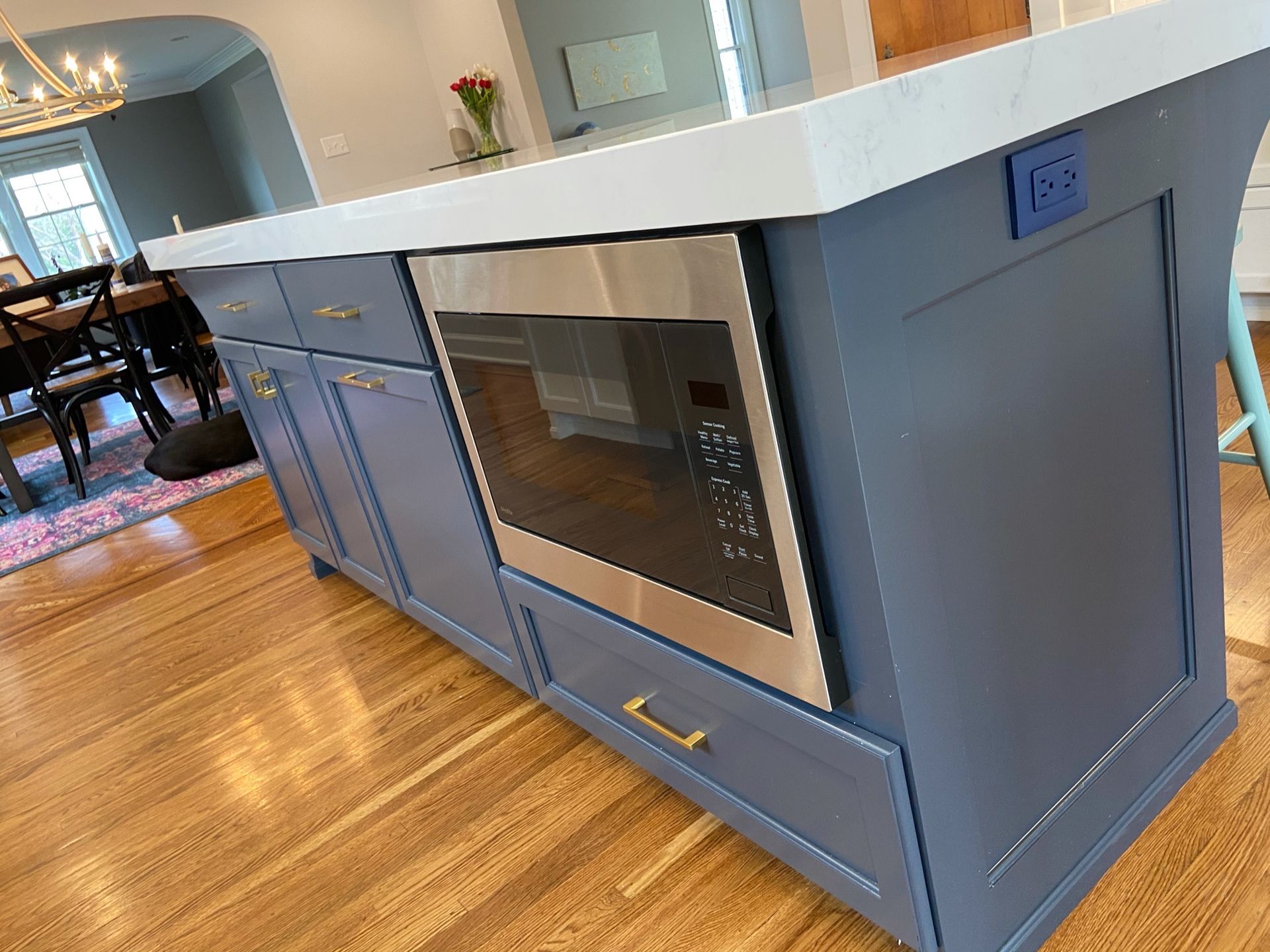A kitchen island with a microwave oven built into it.