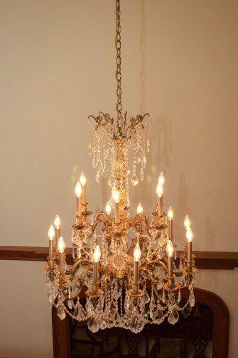 A large chandelier is hanging from the ceiling in a room