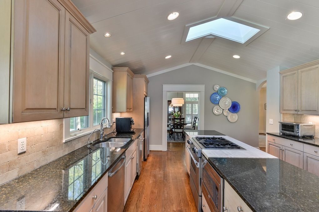 A kitchen with granite counter tops and stainless steel appliances
