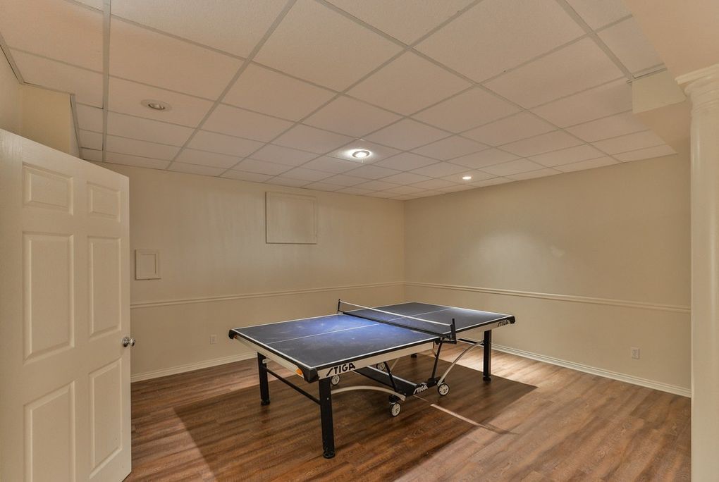There is a ping pong table in the middle of the room.
