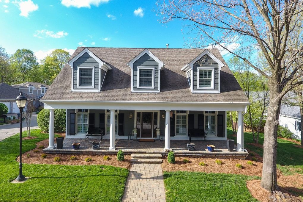 An aerial view of a house with a large porch.