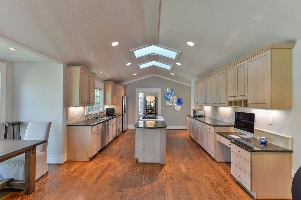 A kitchen with a large island in the middle of the room.