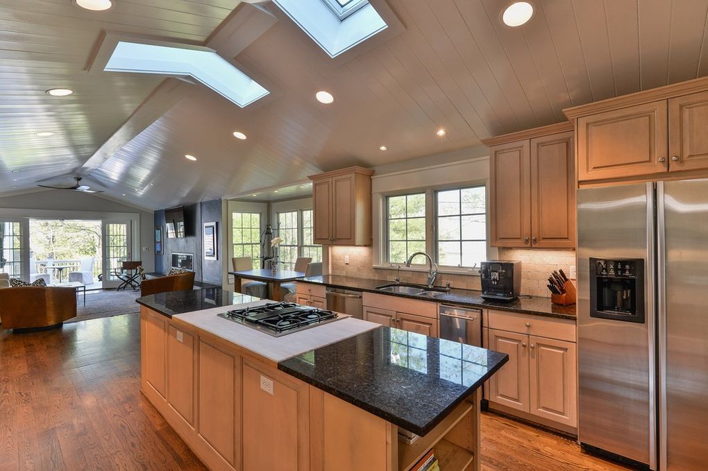 A kitchen with a large island and stainless steel appliances