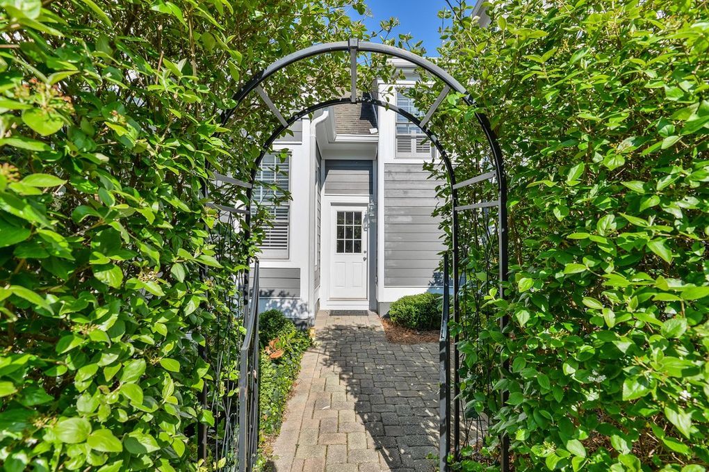 There is a walkway leading to the front door of a house.