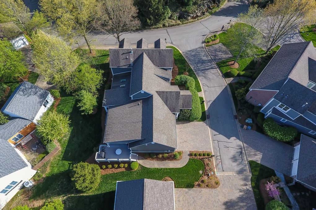 An aerial view of a residential neighborhood with a large house in the middle.