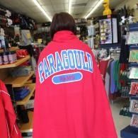 Person in a red blanket with “PARAGOLD” on the back, standing in a store aisle.