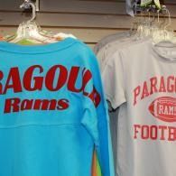 Blue and white Paragould Rams football shirts hanging on store racks