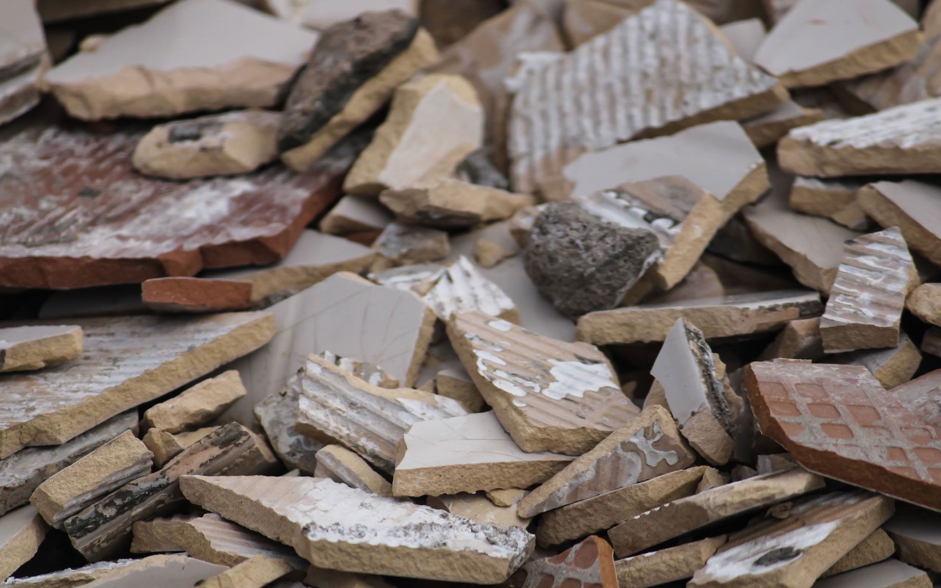 A pile of broken tiles is sitting on the ground