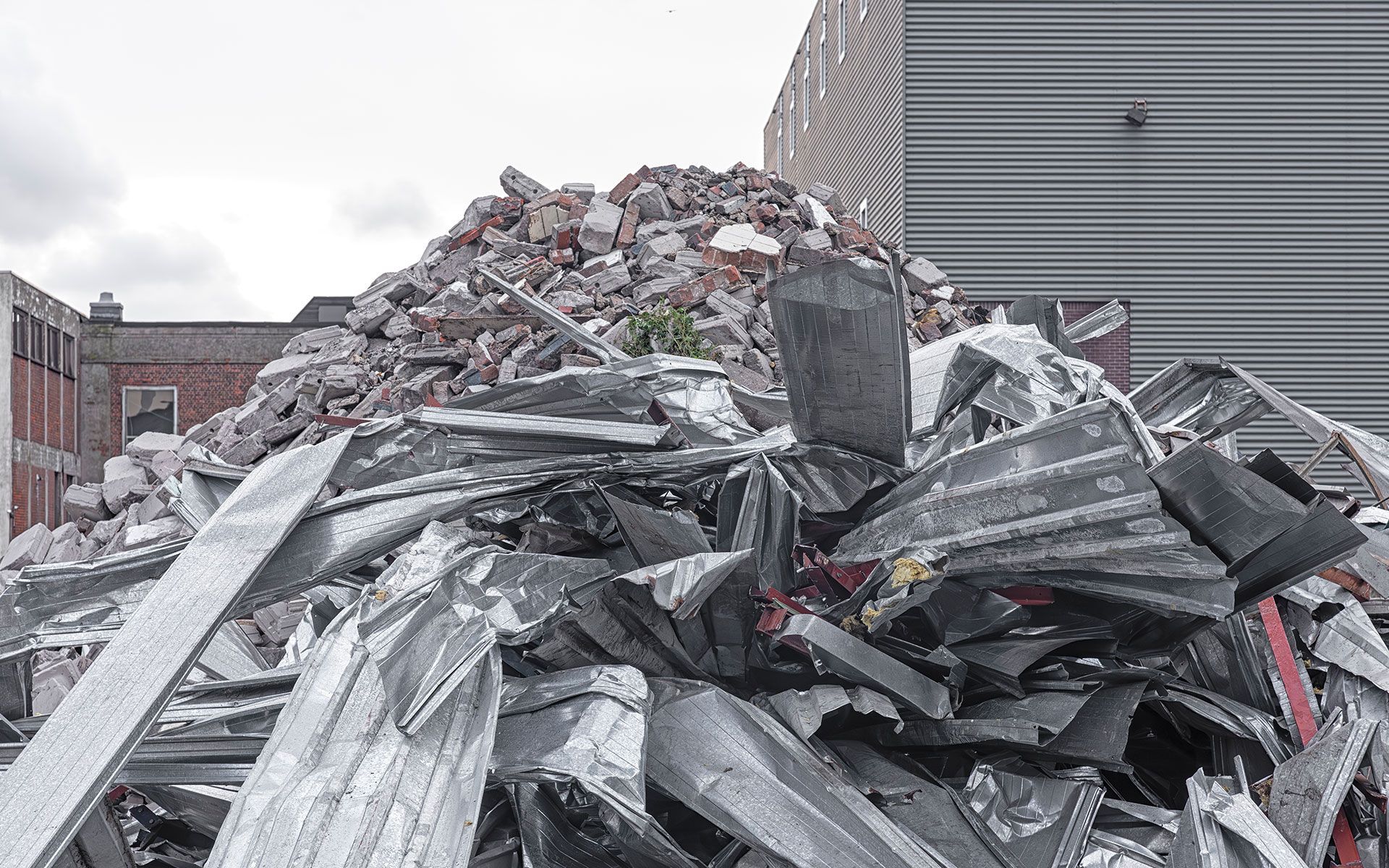 A pile of rubble is sitting in front of a building.