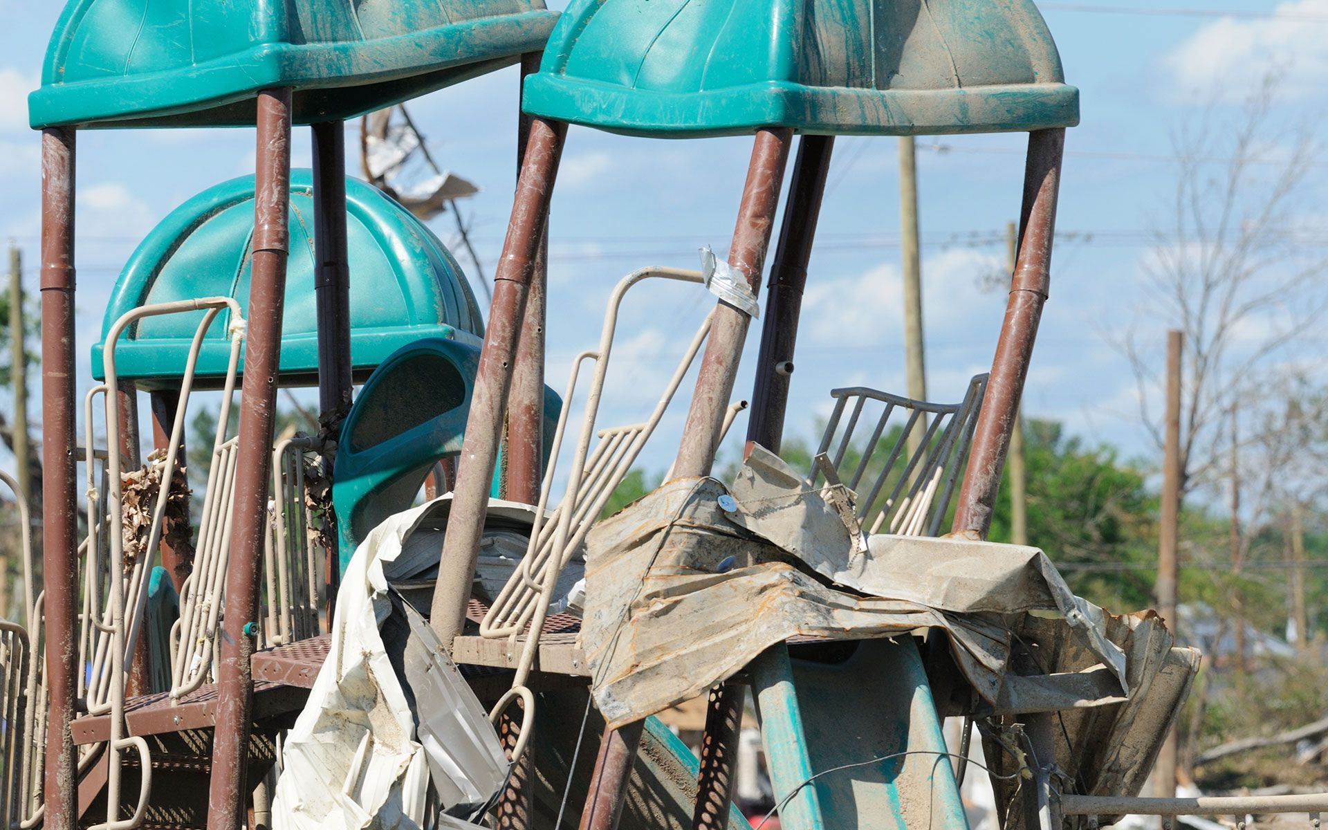 A very old playground with a lot of trash on it