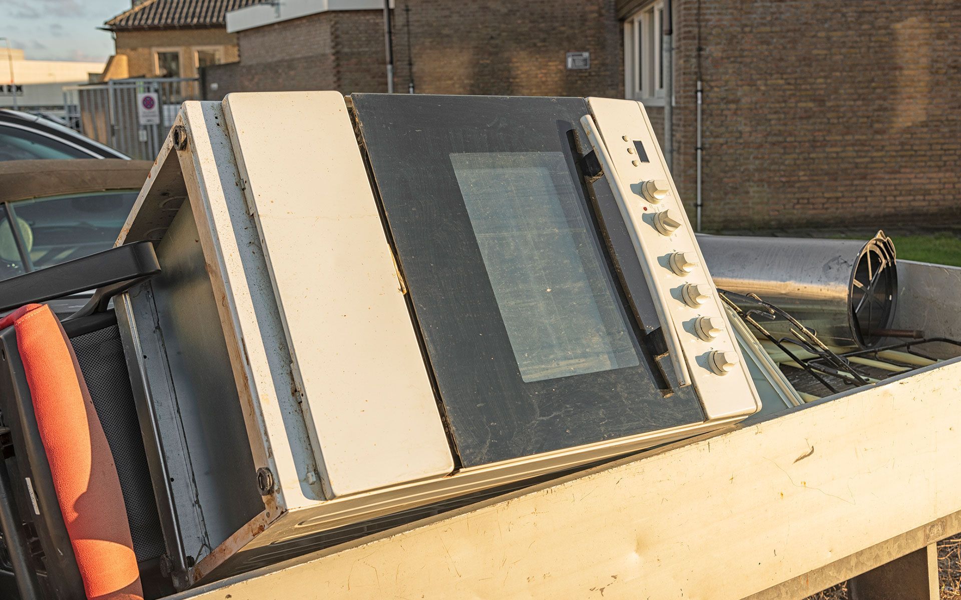 A microwave oven is sitting on top of a wooden table.
