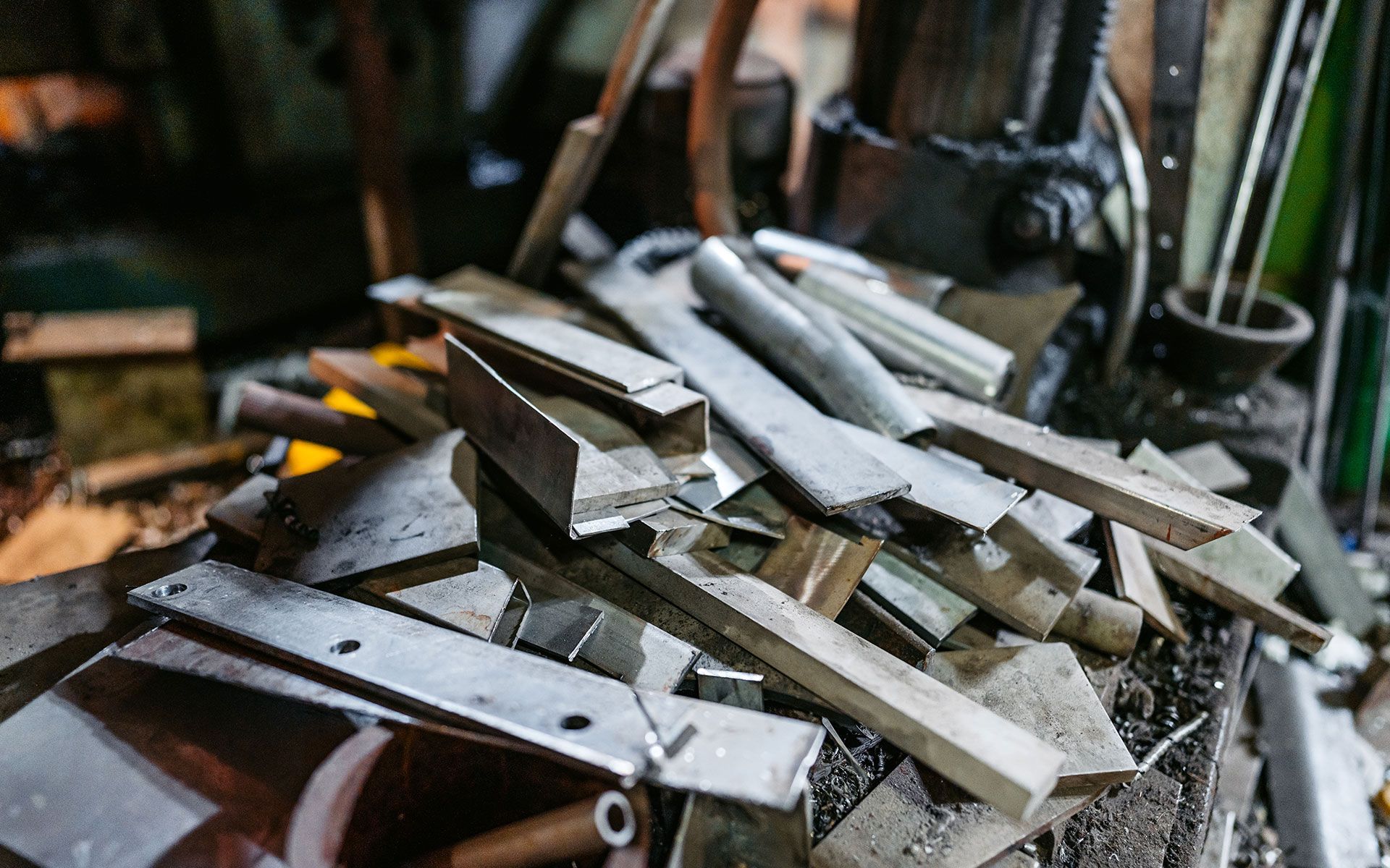 A pile of metal scraps on a table in a workshop.
