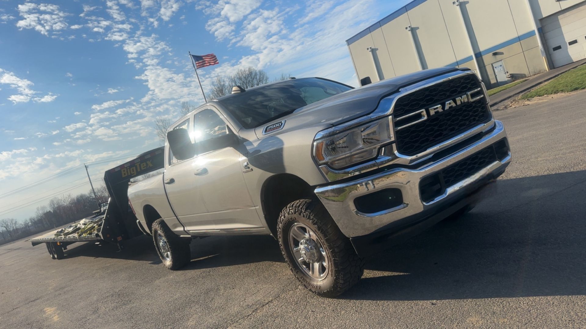 A delivery man is standing next to a white van filled with boxes.